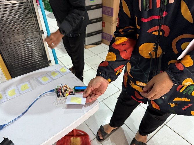 Attendance prototype on a table, RFID card next to the reader